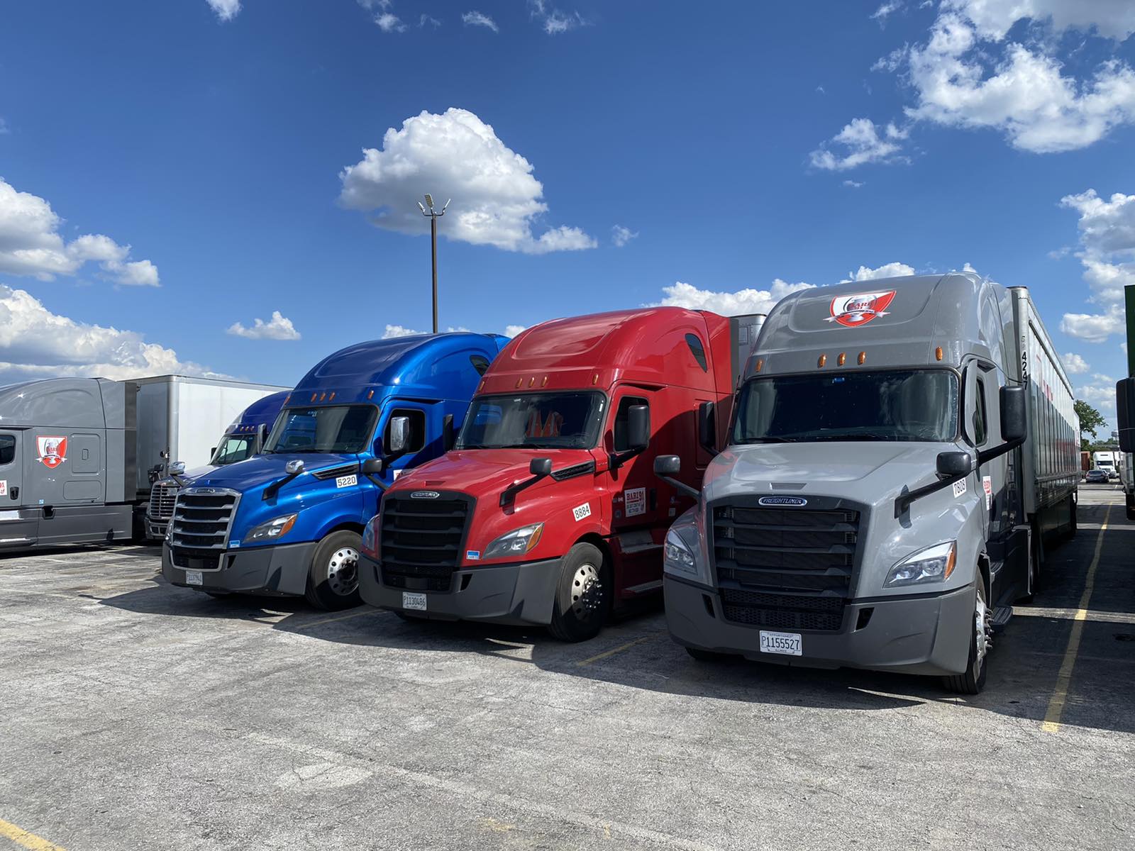 Blue, red, and silver trucks