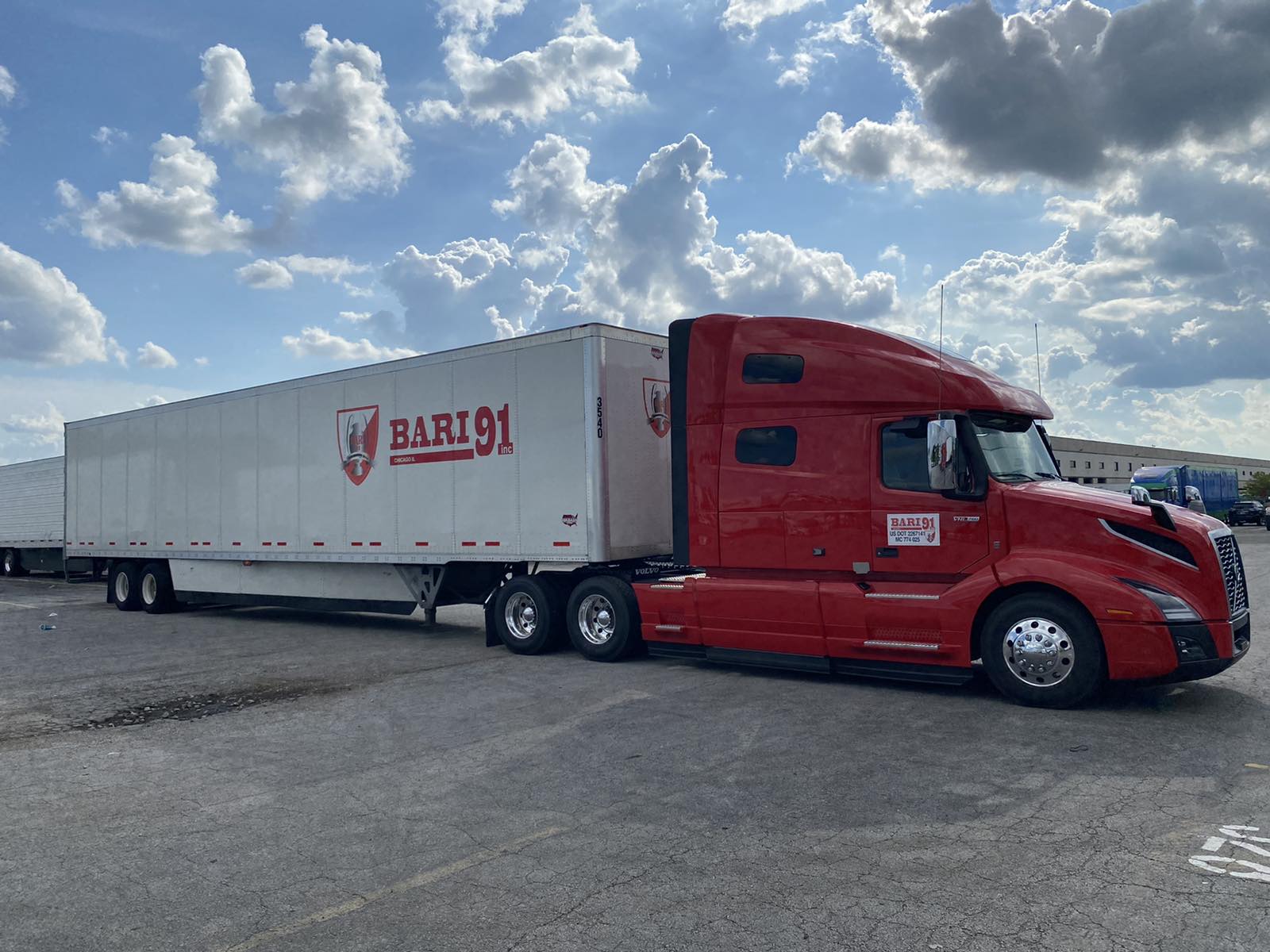Red Volvo with trailer from side